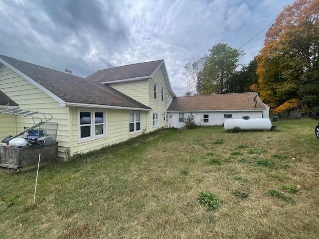 rear view of property with a yard