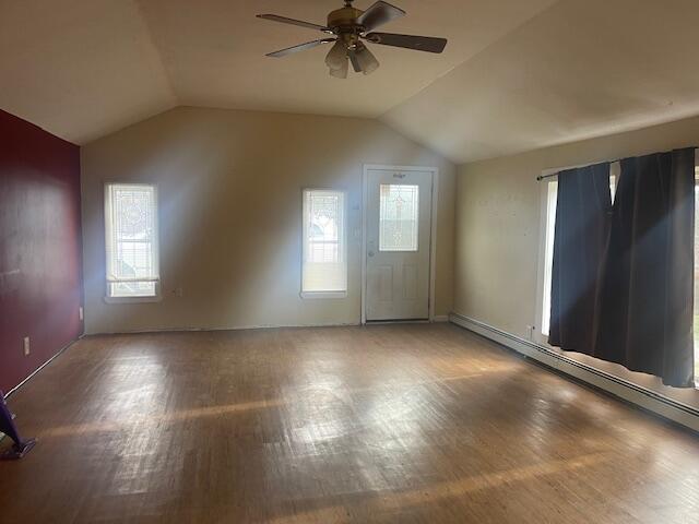 additional living space with wood-type flooring, vaulted ceiling, and ceiling fan