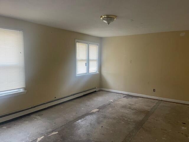 unfurnished room with a baseboard radiator