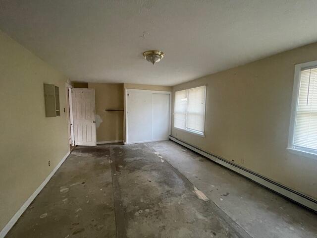 unfurnished bedroom featuring a baseboard radiator