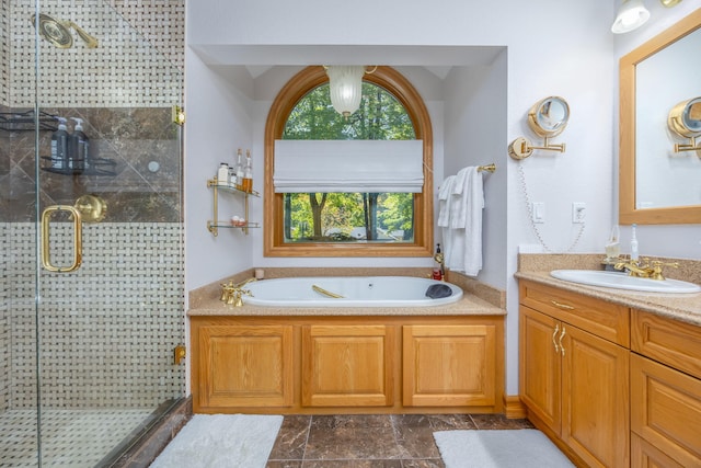 bathroom featuring shower with separate bathtub and vanity