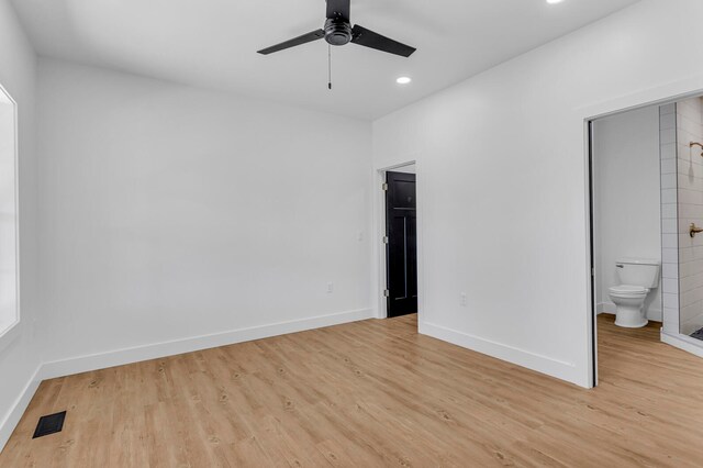 unfurnished bedroom with ceiling fan, light wood-type flooring, and ensuite bath