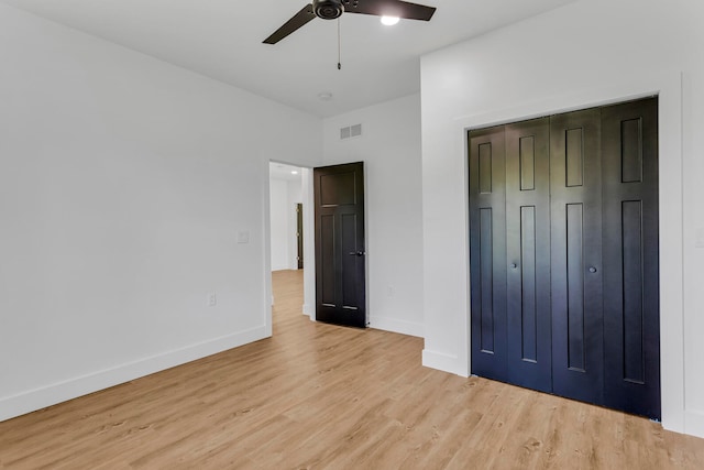 unfurnished bedroom with ceiling fan, a closet, and light hardwood / wood-style floors