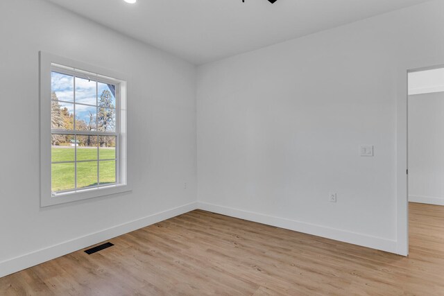 empty room with light wood-type flooring and ceiling fan