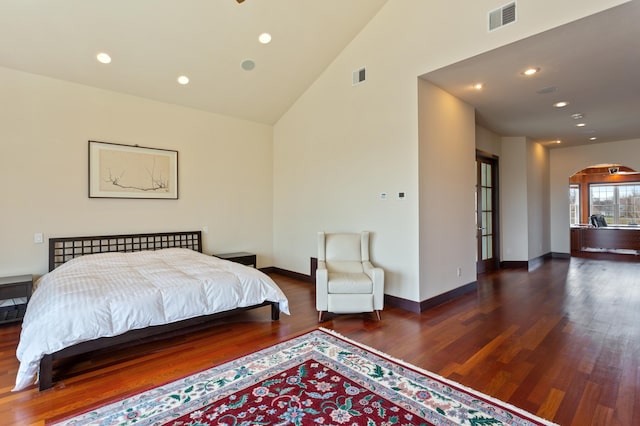 bedroom featuring high vaulted ceiling and dark hardwood / wood-style flooring