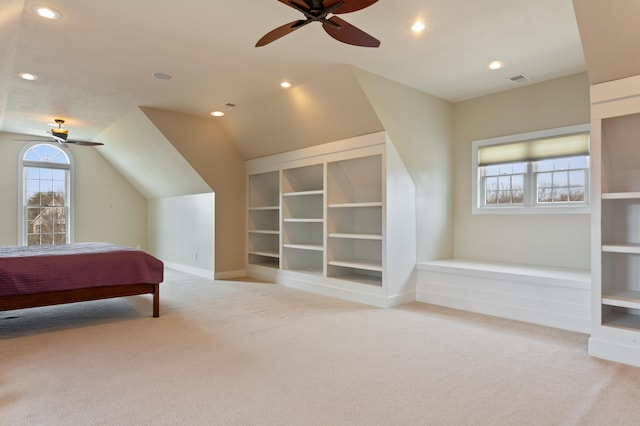 bedroom featuring light carpet, ceiling fan, and vaulted ceiling