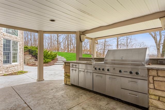 view of patio / terrace with grilling area, an outdoor kitchen, and sink