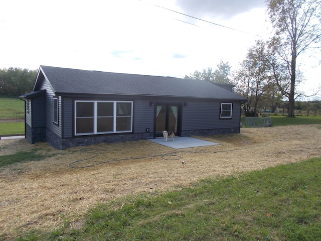 view of front facade with a patio and a front yard