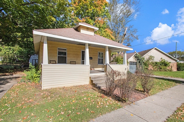 bungalow with a front yard and covered porch