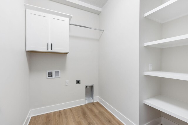 laundry room featuring hookup for a washing machine, light hardwood / wood-style floors, cabinets, and hookup for an electric dryer