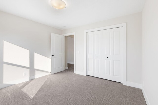 unfurnished bedroom featuring a closet and carpet