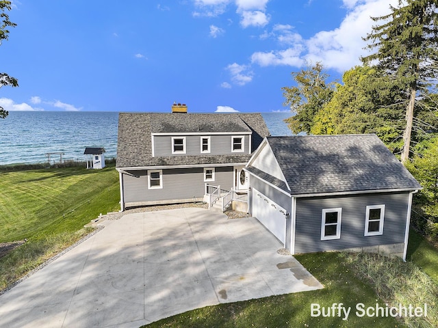 3163 N Scenic Dr, Muskegon, MI 49445 - view of front of house with roof with shingles, an attached garage, a front yard, a chimney, and a water view