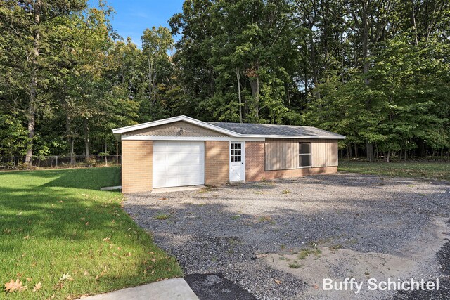 3163 N Scenic Dr, Muskegon, MI 49445 - garage with gravel driveway and fence