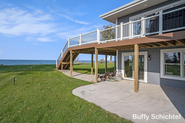 3163 N Scenic Dr, Muskegon, MI 49445 - view of yard with stairway, a patio, and a deck with water view