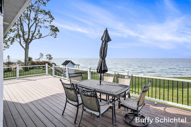 3163 N Scenic Dr, Muskegon, MI 49445 - wooden deck featuring a water view, outdoor dining space, and a lawn
