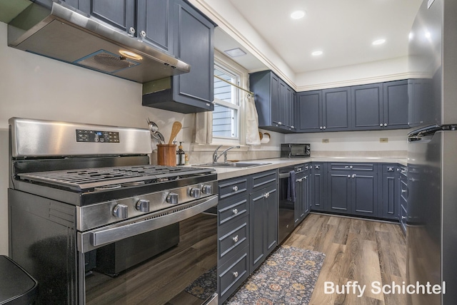 3163 N Scenic Dr, Muskegon, MI 49445 - kitchen featuring a sink, light wood-style floors, under cabinet range hood, light countertops, and appliances with stainless steel finishes