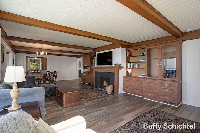 3163 N Scenic Dr, Muskegon, MI 49445 - living area with wood ceiling, wood finished floors, a fireplace with flush hearth, a notable chandelier, and beamed ceiling