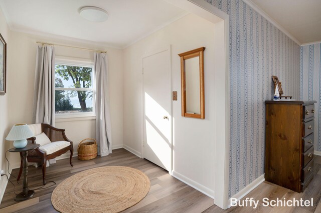 3163 N Scenic Dr, Muskegon, MI 49445 - living area featuring baseboards, ornamental molding, and wood finished floors