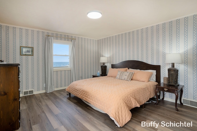 3163 N Scenic Dr, Muskegon, MI 49445 - bedroom with wallpapered walls, baseboards, visible vents, and wood finished floors