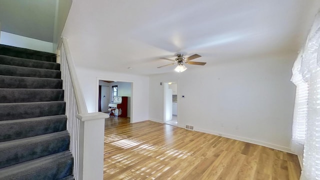 interior space with hardwood / wood-style floors and ceiling fan