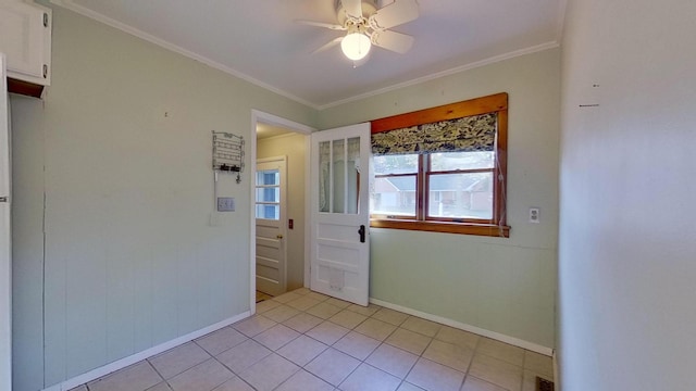 unfurnished room with crown molding, light tile patterned floors, and ceiling fan