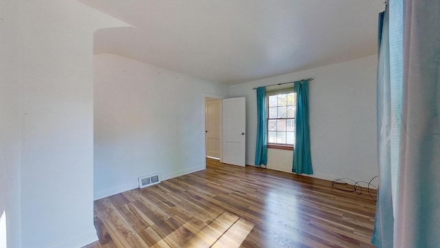 unfurnished room with hardwood / wood-style flooring