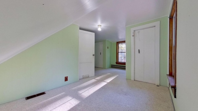 bonus room with lofted ceiling and baseboard heating