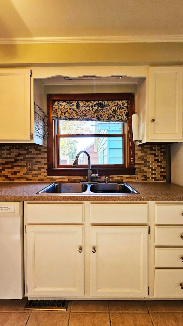 kitchen featuring decorative backsplash, dishwasher, sink, and light tile patterned floors