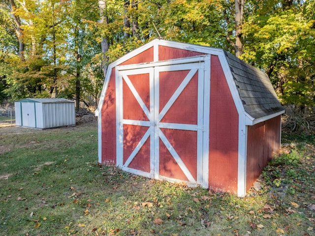 view of outdoor structure featuring a lawn