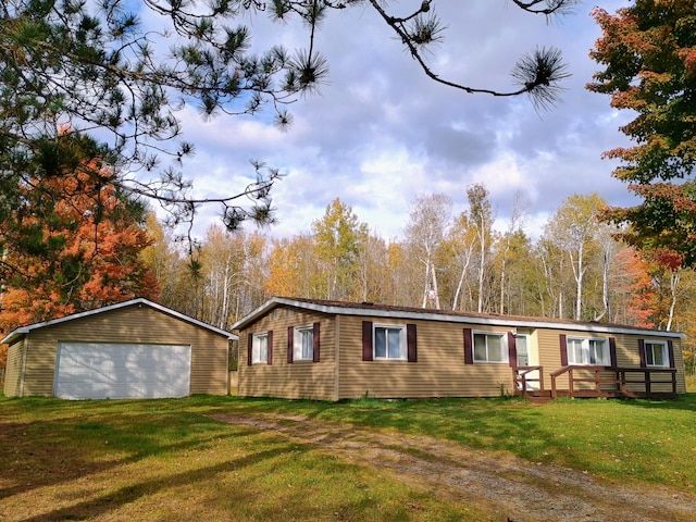 view of front of house with an outbuilding, a front yard, and a garage