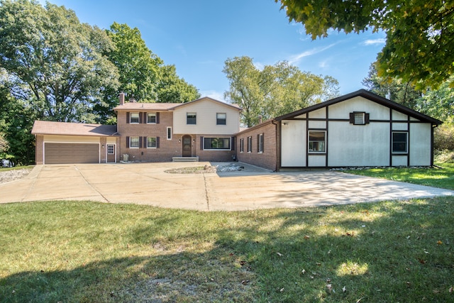 view of front facade with a garage and a front lawn