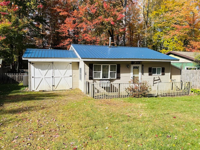 single story home with a storage unit and a front lawn