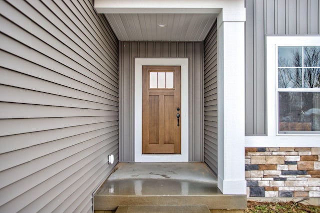 doorway to property with stone siding