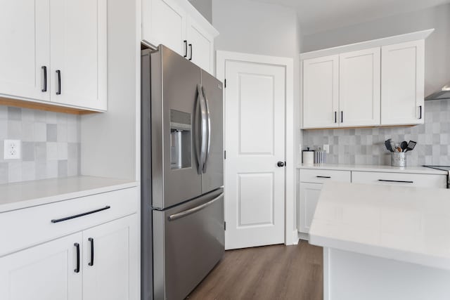 kitchen with dark wood finished floors, white cabinetry, stainless steel refrigerator with ice dispenser, and light countertops