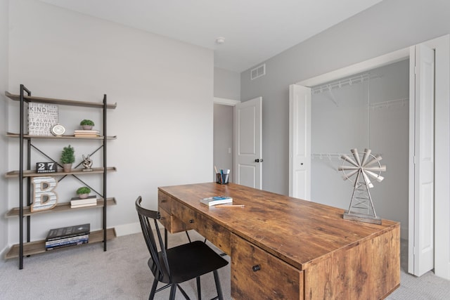 office area featuring light carpet, visible vents, and baseboards