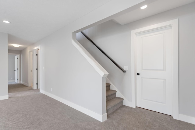 staircase featuring carpet, baseboards, and recessed lighting