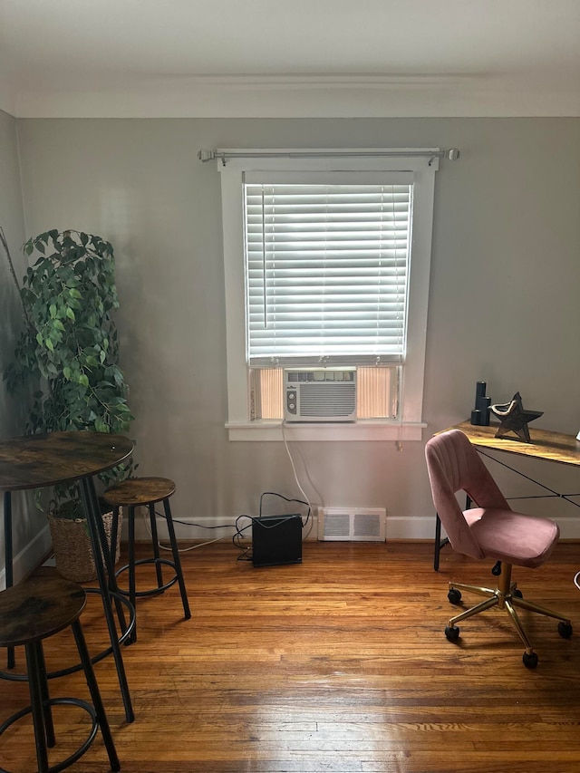 office area with cooling unit and hardwood / wood-style flooring