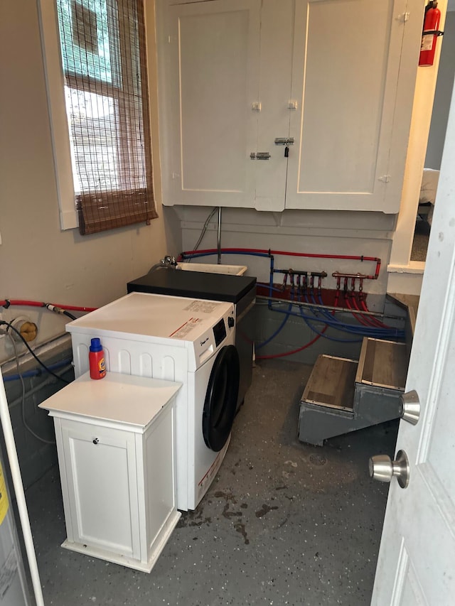 laundry room featuring cabinets