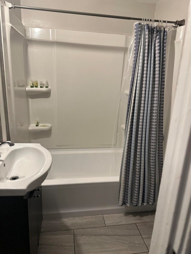 bathroom featuring vanity, hardwood / wood-style floors, and shower / tub combo with curtain