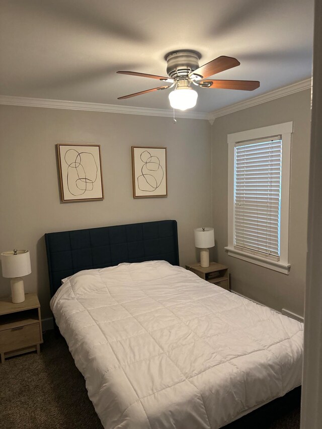 carpeted bedroom with ornamental molding and ceiling fan