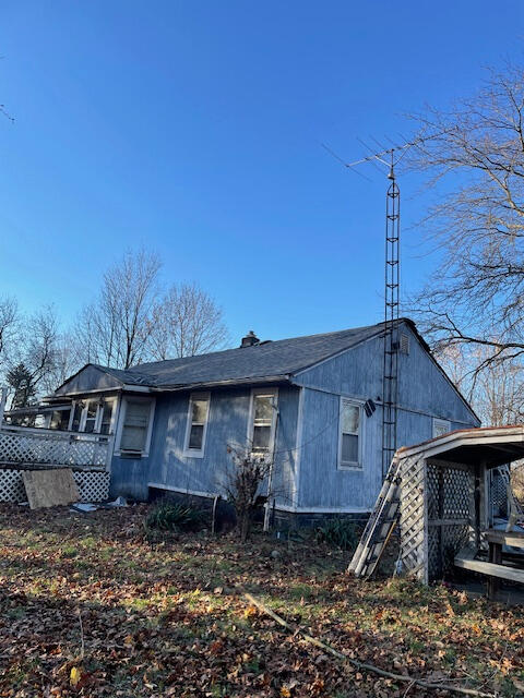 rear view of property featuring a deck