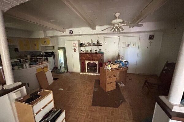 kitchen featuring parquet flooring, beamed ceiling, and ceiling fan