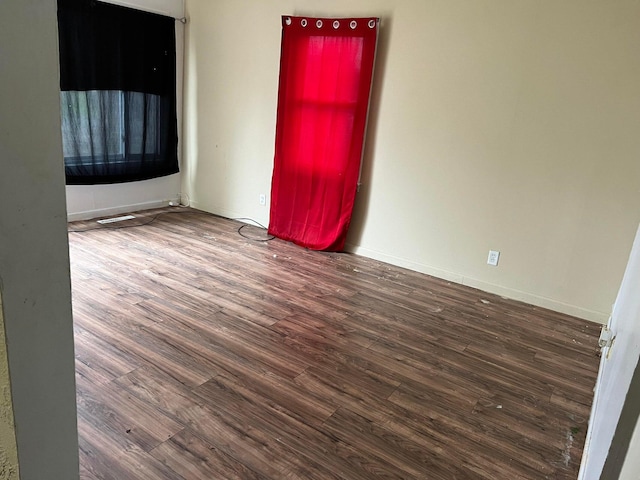 spare room with dark hardwood / wood-style floors