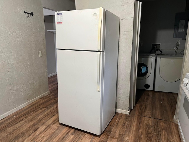 kitchen featuring electric panel, washer and clothes dryer, stove, white fridge, and hardwood / wood-style flooring