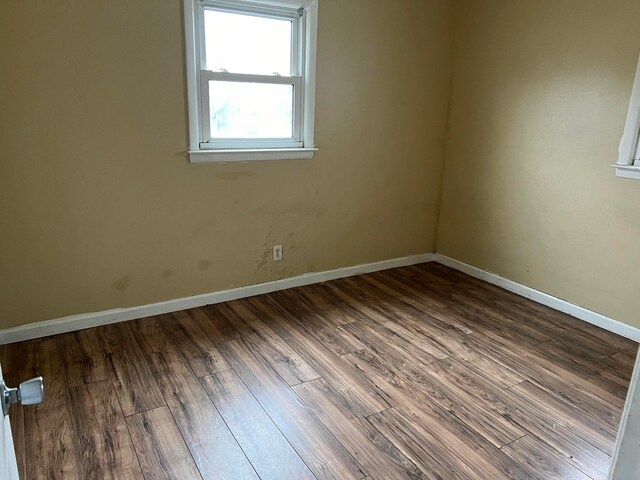 empty room with hardwood / wood-style flooring