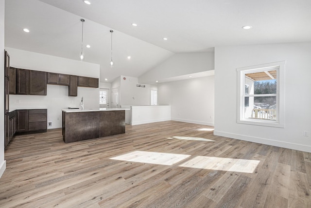 unfurnished living room with high vaulted ceiling and light hardwood / wood-style floors