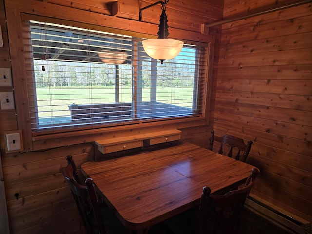 dining area with wooden walls and a baseboard radiator