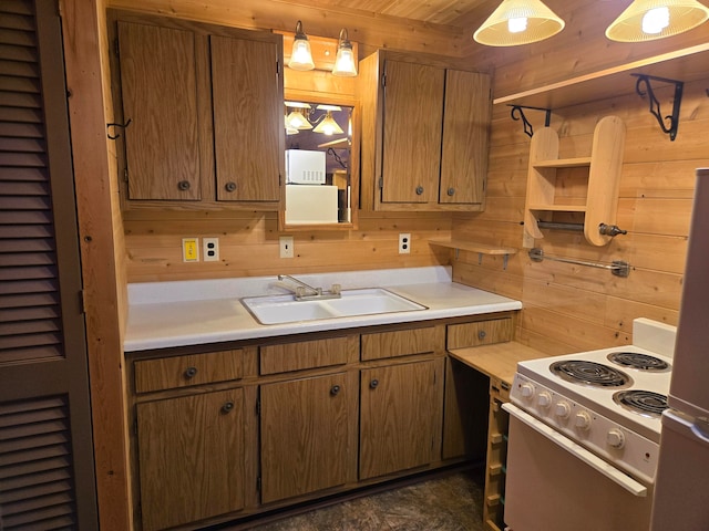 kitchen with wooden walls, sink, fridge, decorative light fixtures, and white range with electric cooktop