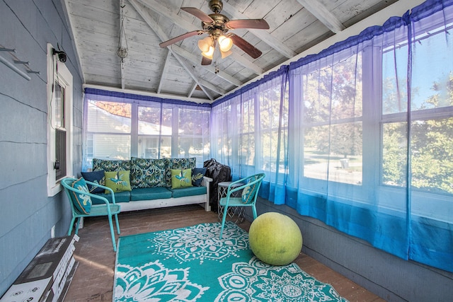 sunroom / solarium featuring ceiling fan, lofted ceiling with beams, and wooden ceiling