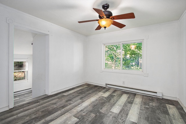 empty room with dark wood-type flooring, a baseboard heating unit, and plenty of natural light